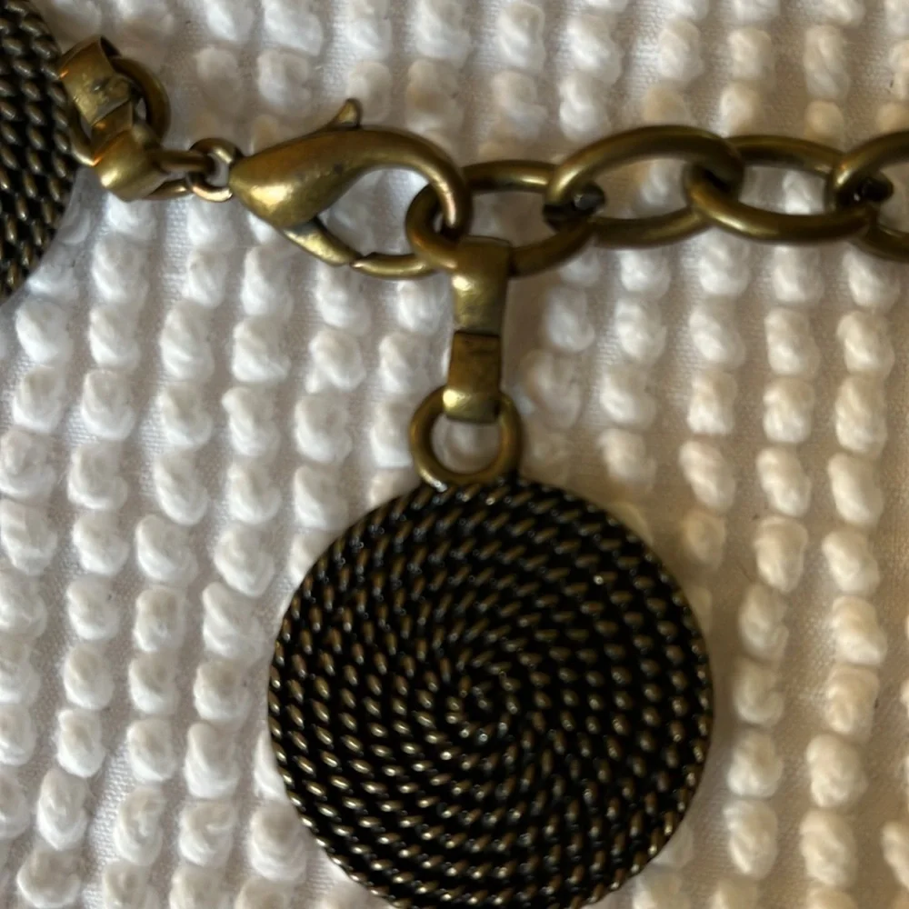 Women’s chain with metal circular and rectangular patterns belt.